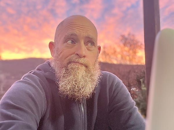 Man Looking Confused at Computer (With Sunrise in the Background)